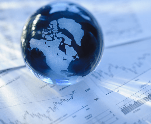 glass-globe-on-financial_papers-blue