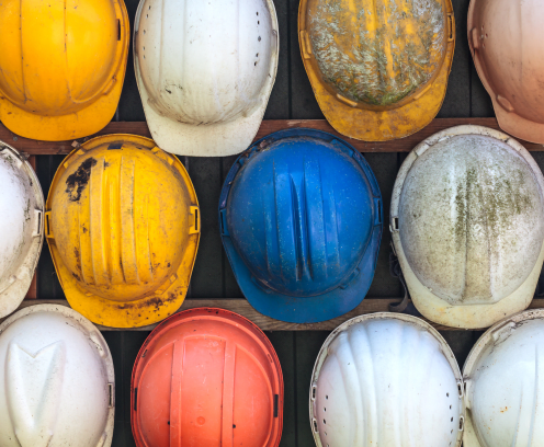 Old and worn colorful construction helmets