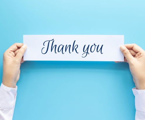 woman hand holding card with the word thank you isolated on blue background, studio shot