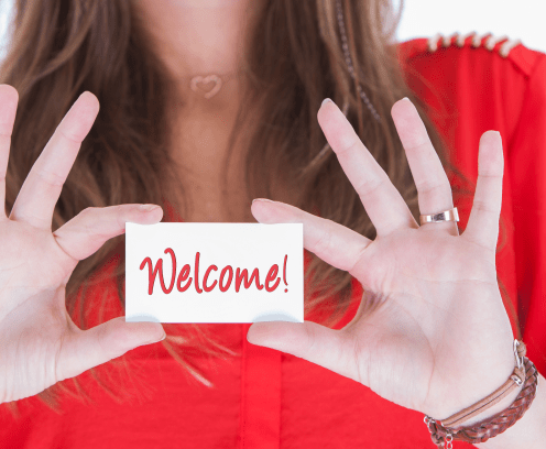 Woman in red showing a business card, welcome