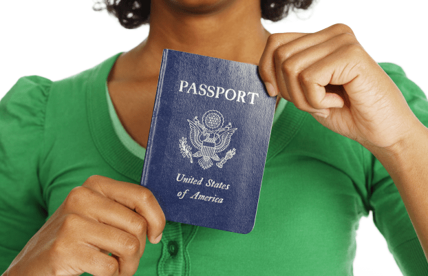 Close-up of a passport being held in a woman's hands.