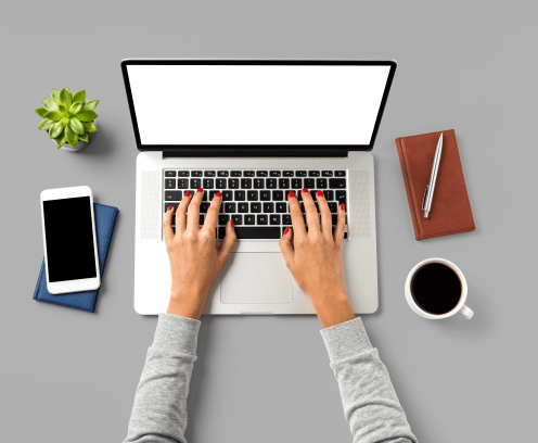 overhead-shot-offfice-desktop-with-female-hands-working-on-laptop