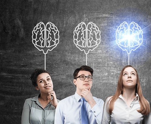 four business people in front of brains drawn on chalkboard