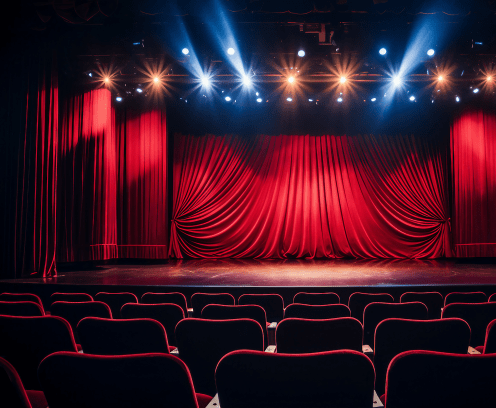 Empty stage with bright lights and red curtains