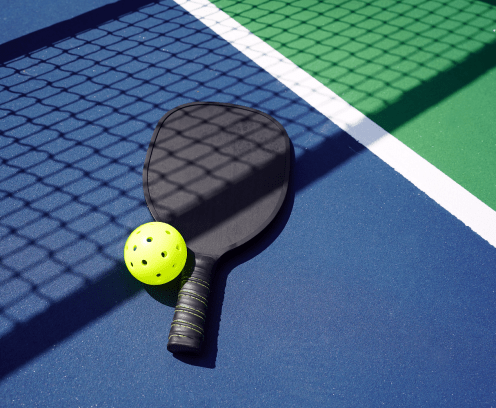 pickleball-paddle-and-ball-on-court