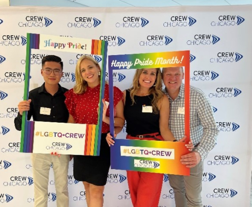 Four people celebrating pride month