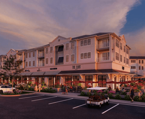 Resort apartment building over retail shops at sunset.