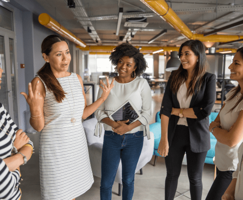 Women standing in a modern office talking