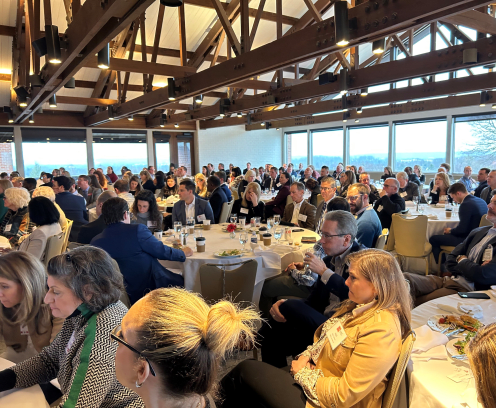 Room filled with tables and people.