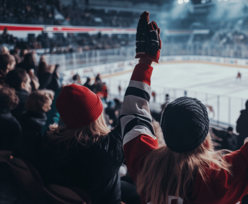 woman raising hands at a hockey game