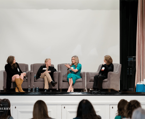 Four women sitting on a panel.