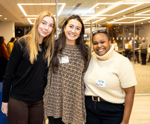 three diverse ladies standing in front of mirrored wall
