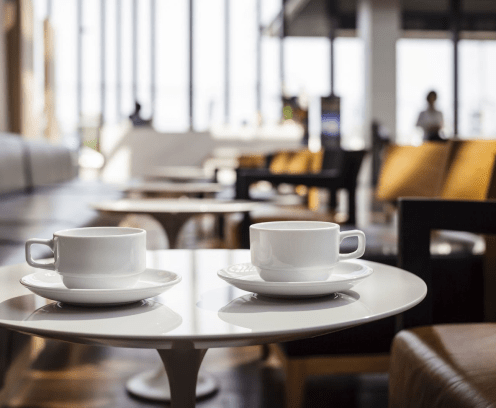 Two coffee cups on small table in a lounge