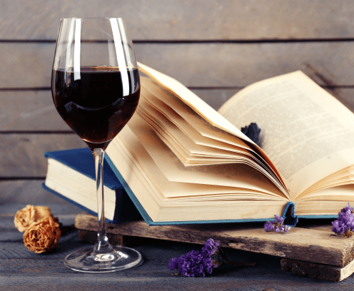 beautiful-composition-glass-of-wine-with-old-books-on-table-close-up