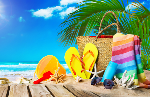 Tropical beach with sunbathing accessories, summer holiday background. Travel and beach family vacation