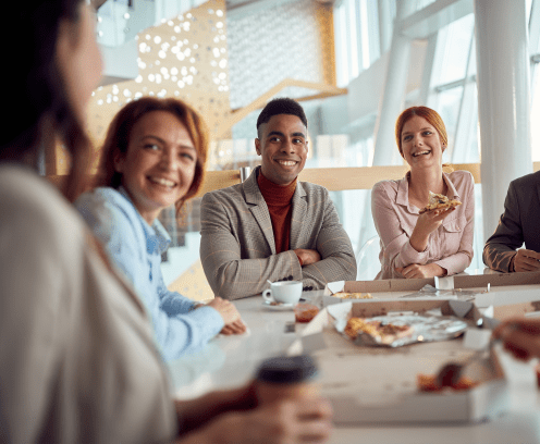 Young business team has a friendly talk during a lunch break in a pleasant atmosphere in the company building. Business, people, company