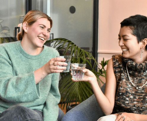 two women drinking cocktails