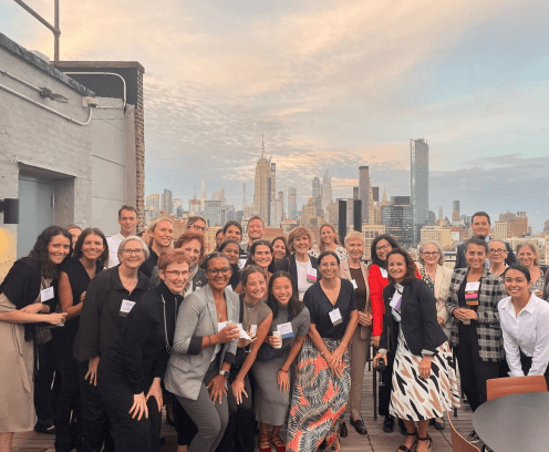 Group of people on the rooftop with a skyline in the background