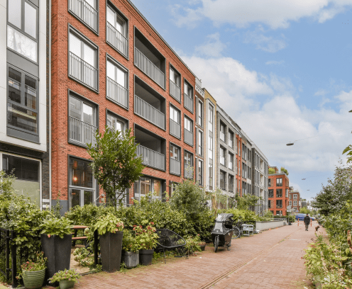 Contemporary residential buildings showcase sleek designs and harmonious layouts, surrounded by lush greenery and walkable paths, emphasizing urban living.