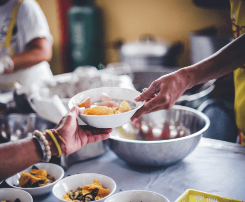 bal_food_in_bowls_served_by_a_hand_with_bracelets_on