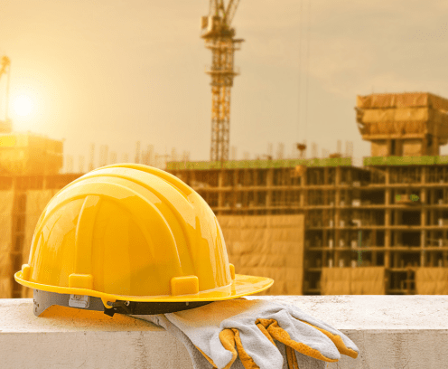 Hard hat against set against a high rise construction site