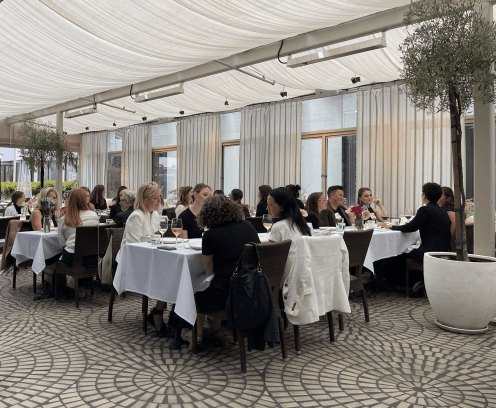 women sitting at a table and eating and talking