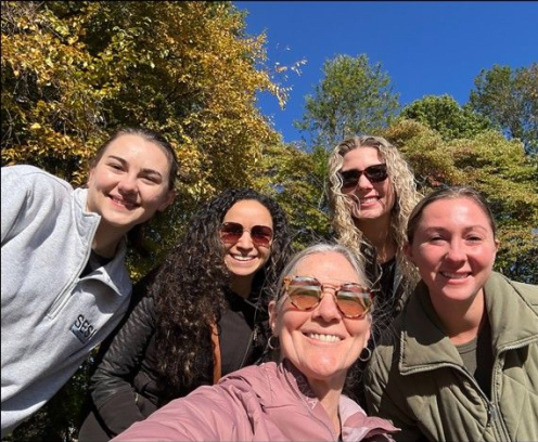 Five ladies at the park, with trees in the background