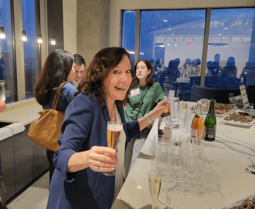 Anne Klein holding champagne glass