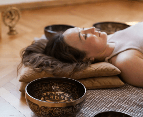 lady on a pillow with gold bowls