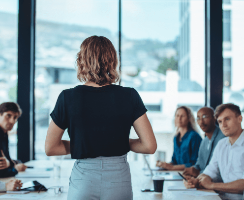 Woman addressing a meeting in office boardroom. Businesswoman having a meeting with her office staff.