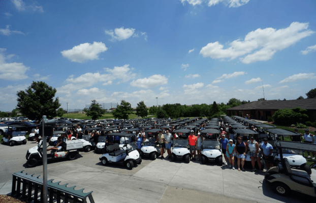 CREW Omaha group of golf players standing next to golf carts
