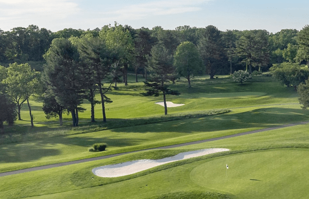 View of golf course, sand traps, trees.