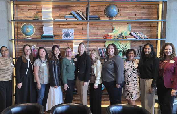 Ladies standing with shelves behind them