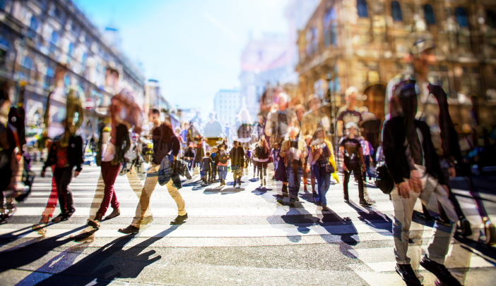 blurred photo of a crowd of people walking on a busy city street