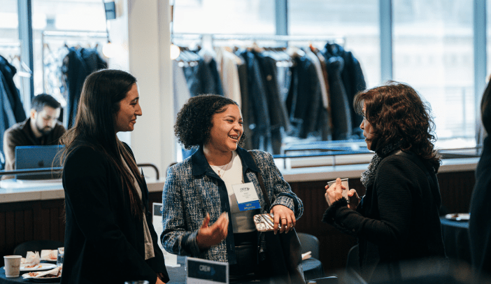 Three professional women networking at CREW NY event