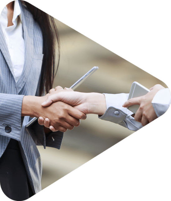 Business women shaking hands with iphone and tablets in their hands
