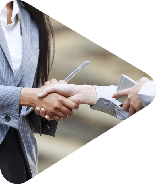 business women shaking hands with iphone and tablets in their hands