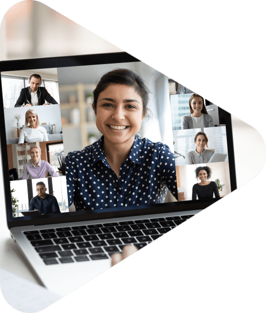 Woman sit at desk looking at computer screen where collage of diverse people webcam view. Indian ethnicity young woman lead video call distant chat, group of different mates using videoconference app