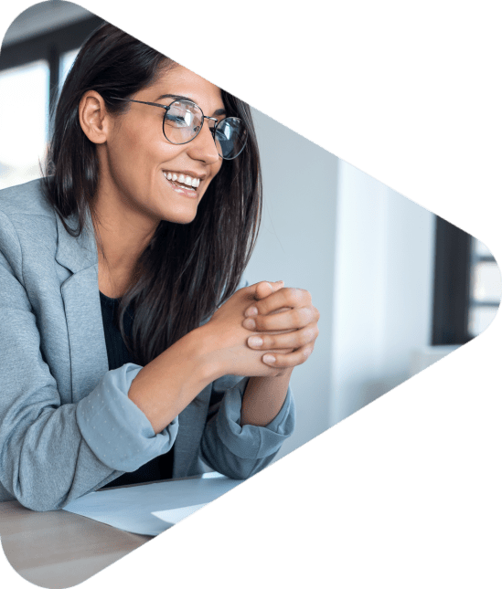 Shot of confident business woman looking and speaking through the webcam while making a video conference with laptop from the office.