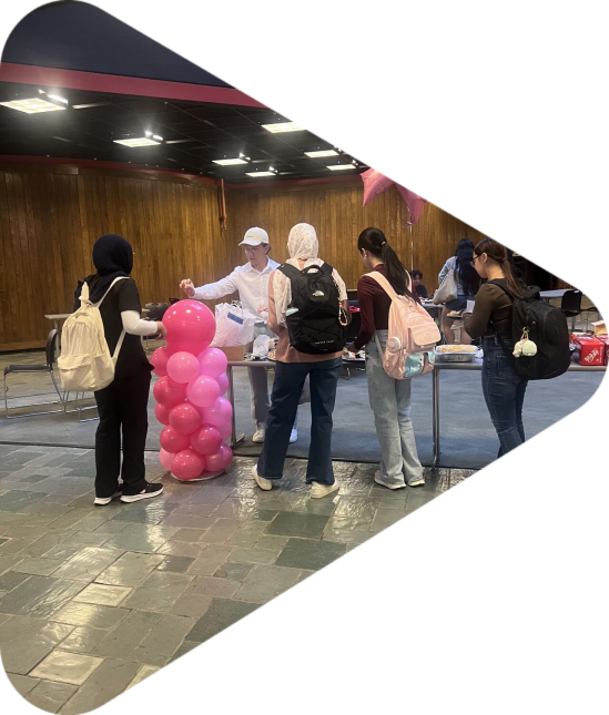 Women standing by pink balloons