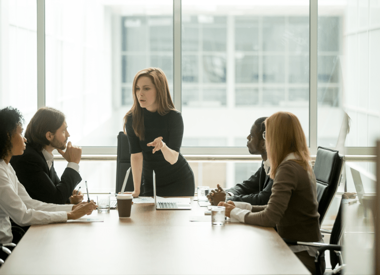 woman leading serious discussion at conference table