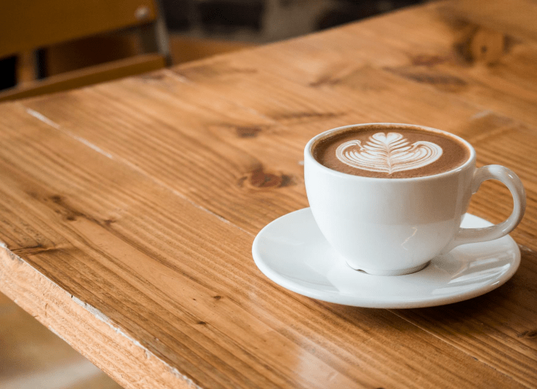 full-coffee-cup-on-wooden-table