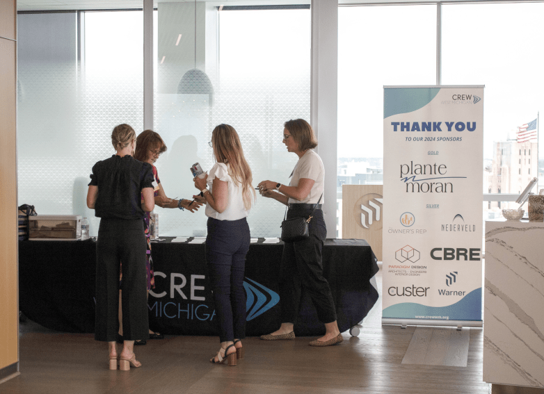 Members in front of a promotional table
