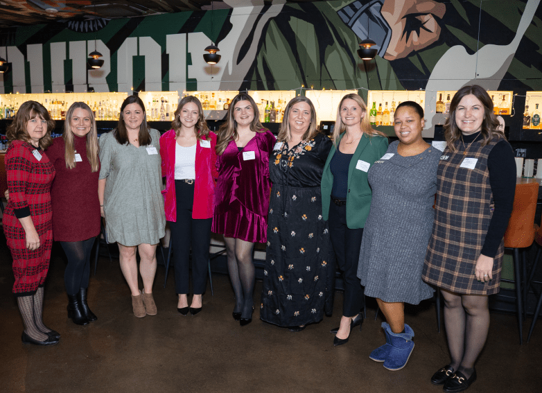 group of 9 women smiling for camera