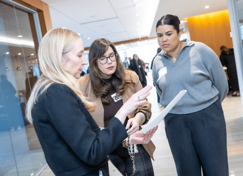 three ladies having a conversation at an event