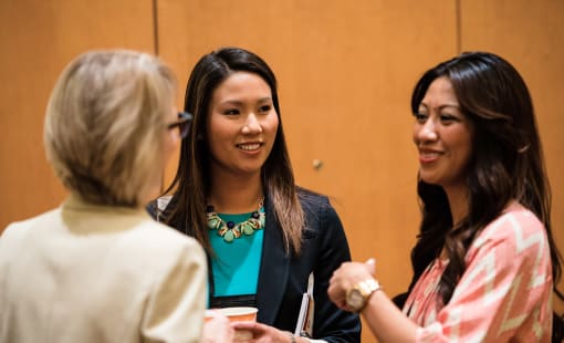 Three women talking at CREW networking event