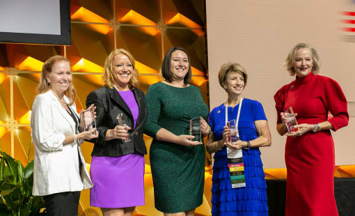 Five women holding CREW Impact awards