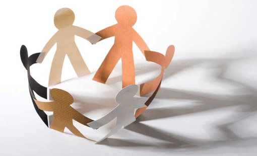 multi colored paper figures holding hands in a circle