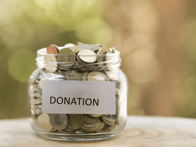 glass jar with change labeled donation