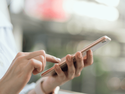 woman using smartphone on staircase in public areas, During leisure time. The concept of using the phone is essential in everyday life.